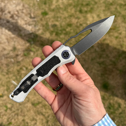Heretic Blizzard Wraith V4 SE Manual Knife – 3.7″ MagnaCut Battleworn Black Blade, Blue Titanium Collar – Made in USA