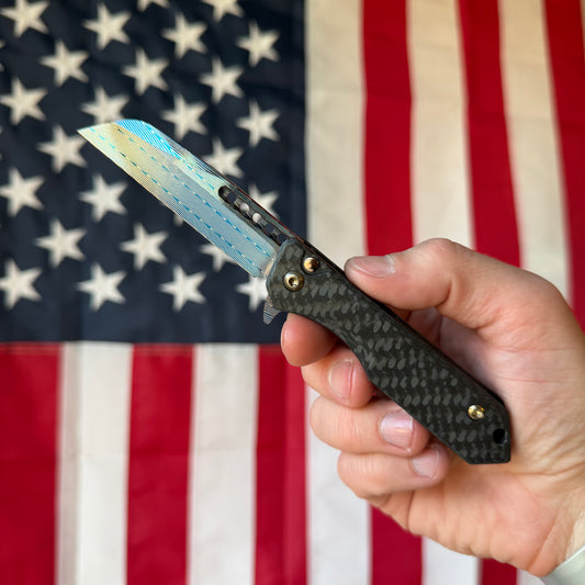 Heretic Knives Jinn Manual Knife – Carbon Fiber Chassis, Vegas Forge Herringbone Damascus, Hand Ground Blued Blade, Flamed Titanium Clip – Serialized – Made in USA (S/N 022)