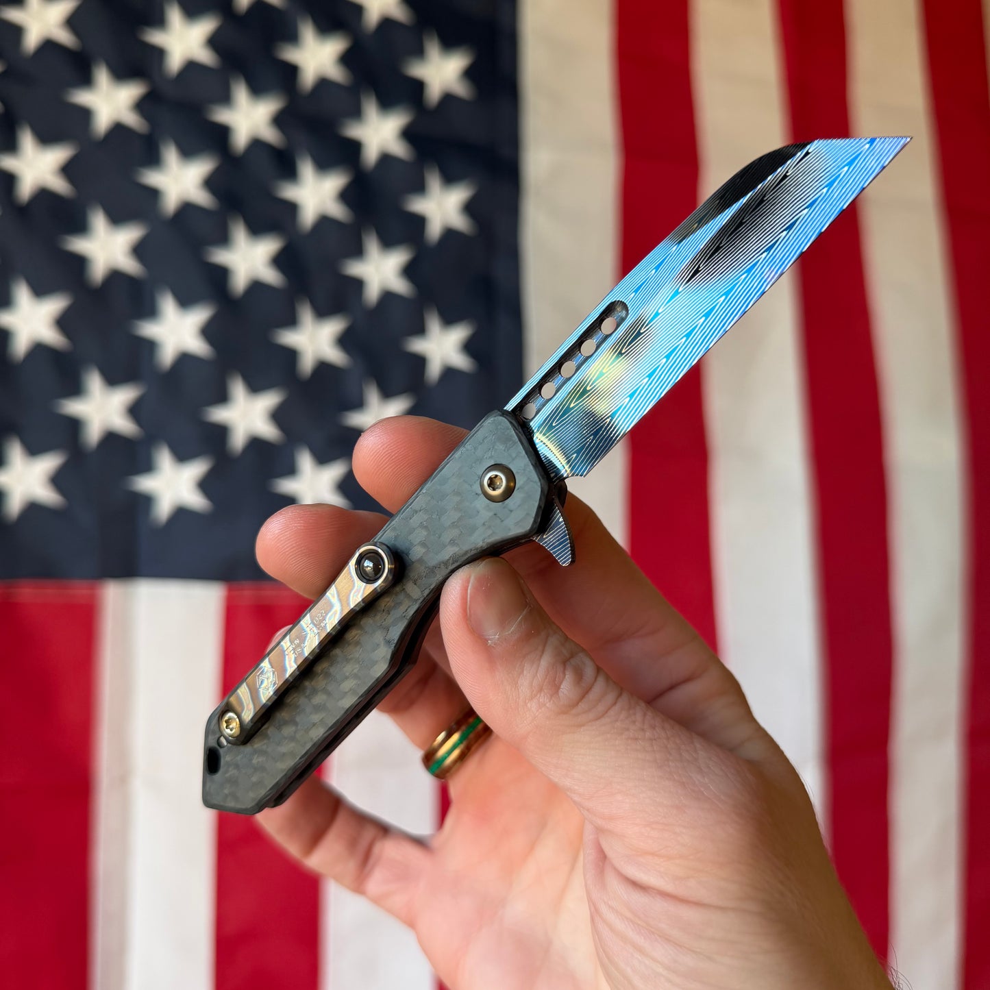 Heretic Knives Jinn Manual Knife – Carbon Fiber Chassis, Vegas Forge Herringbone Damascus, Hand Ground Blued Blade, Flamed Titanium Clip – Serialized – Made in USA (S/N 022)