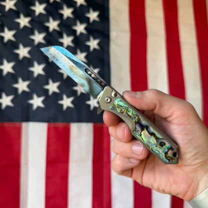 Heretic Knives Jinn Manual Knife – Titanium Chassis, Vegas Forge Herringbone Damascus, Hand Ground Blued Blade, Abalone Inlays – Serialized – Made in USA (S/N 013)