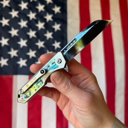 Heretic Knives Jinn Manual Knife – Titanium Chassis, Vegas Forge Herringbone Damascus, Hand Ground Blued Blade, Abalone Inlays – Serialized – Made in USA (S/N 013)
