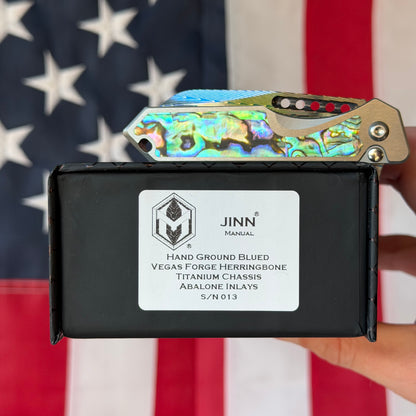Heretic Knives Jinn Manual Knife – Titanium Chassis, Vegas Forge Herringbone Damascus, Hand Ground Blued Blade, Abalone Inlays – Serialized – Made in USA (S/N 013)