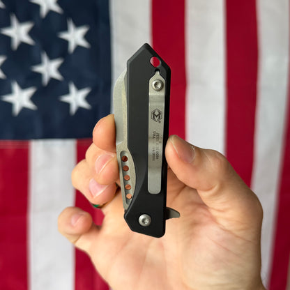 Heretic Jinn Manual 3.0" Button Lock Flipper – Battleworn MagnaCut, Black Chassis – Made in USA (H213-5A)
