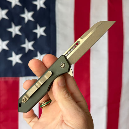 Heretic Jinn Manual 3.0" Button Lock Flipper – Bronze MagnaCut, OD Green Chassis – Made in USA (H213-7AGRN)