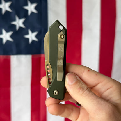 Heretic Jinn Manual 3.0" Button Lock Flipper – Bronze MagnaCut, OD Green Chassis – Made in USA (H213-7AGRN)