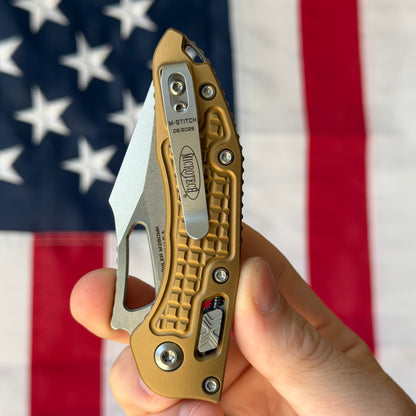 Microtech M-Stitch RAM-LOK 3.05" Manual – Tan Frag Aluminum, M390MK Stonewash – Made in USA (169MRL-10FRTA)