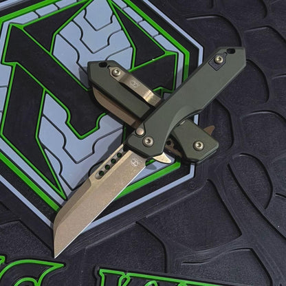 Heretic Jinn Manual 3.0" Button Lock Flipper – Bronze MagnaCut, OD Green Chassis – Made in USA (H213-7AGRN)